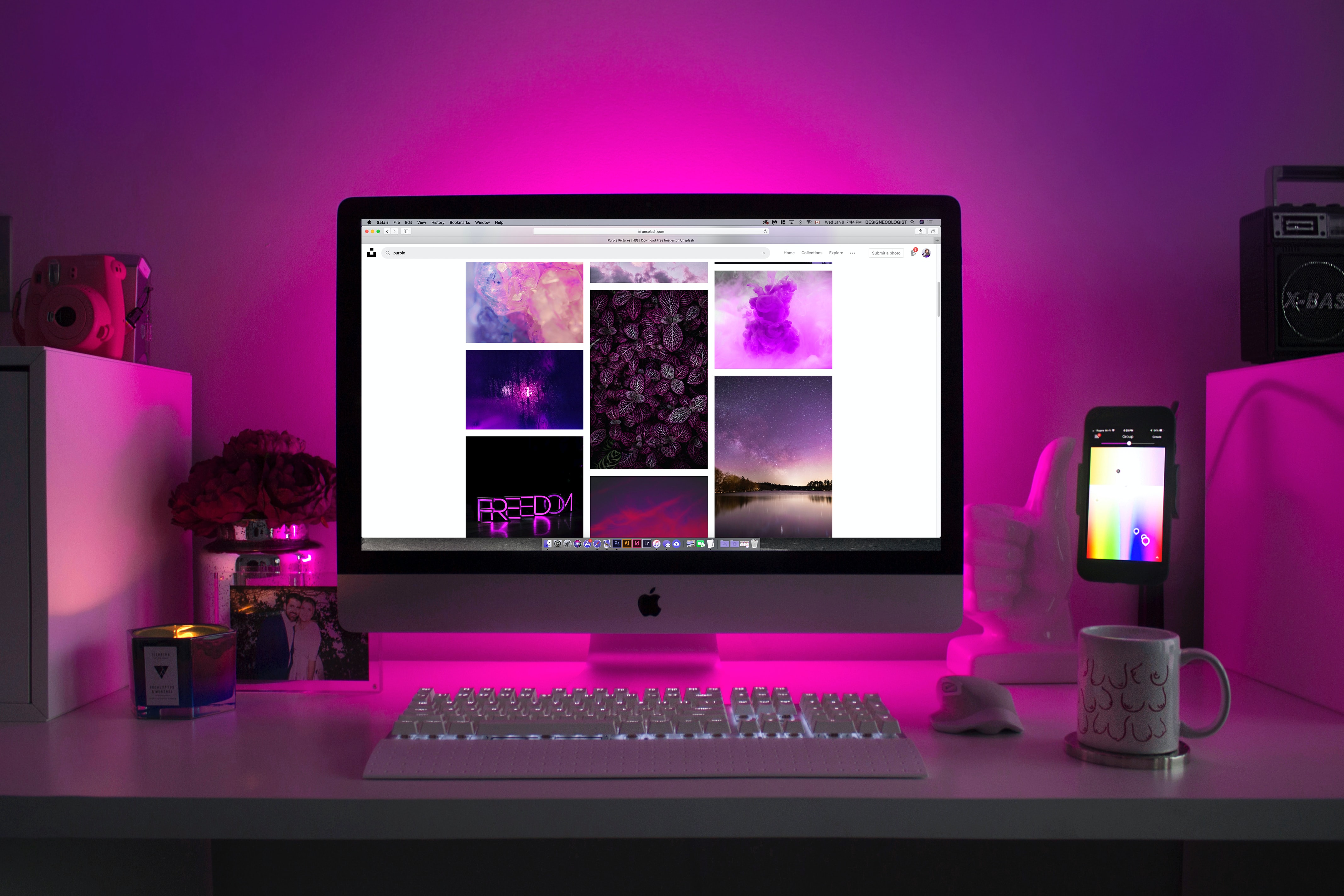 Apple computer with pink light behind it 