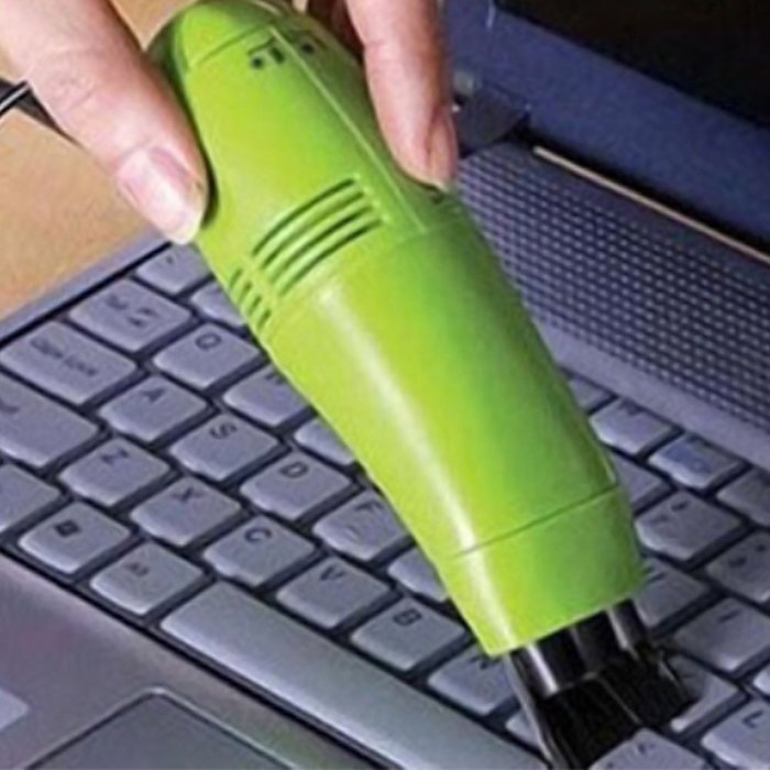 A keyboard vacuum cleaner being used on keyboard