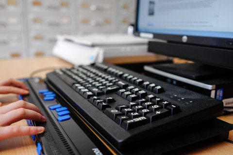 keyboard being used by a visually impaired person